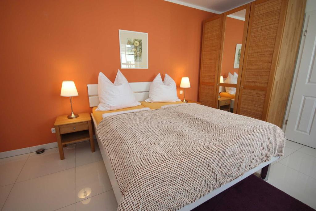 a bedroom with a large bed with white pillows at Appartement Louise in Wustrow