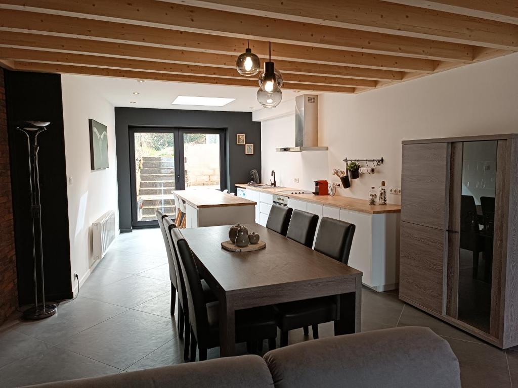 a kitchen and dining room with a table and chairs at Clénoliette in Cerfontaine