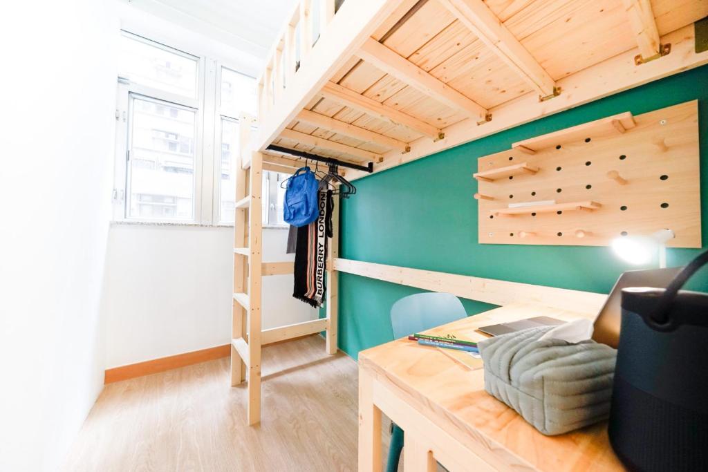 a small room with a loft bed and a desk at CoLiving - Lockhart Road 388 in Hong Kong