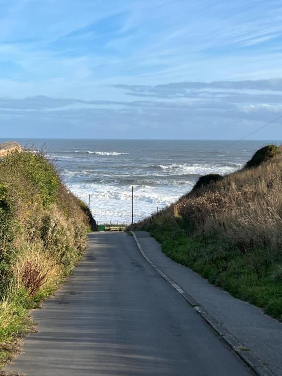 a road leading to the ocean on a beach at Sea La Vie in Cayton