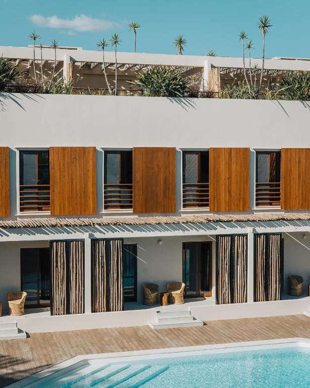a hotel with a pool in front of it at AlmaLusa Comporta in Comporta