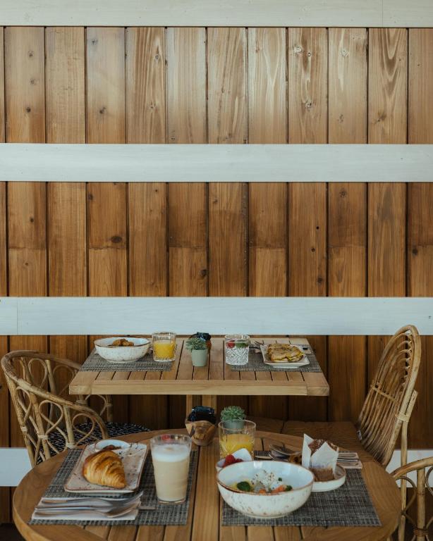 a table with two tables with breakfast foods on it at AlmaLusa Comporta in Comporta