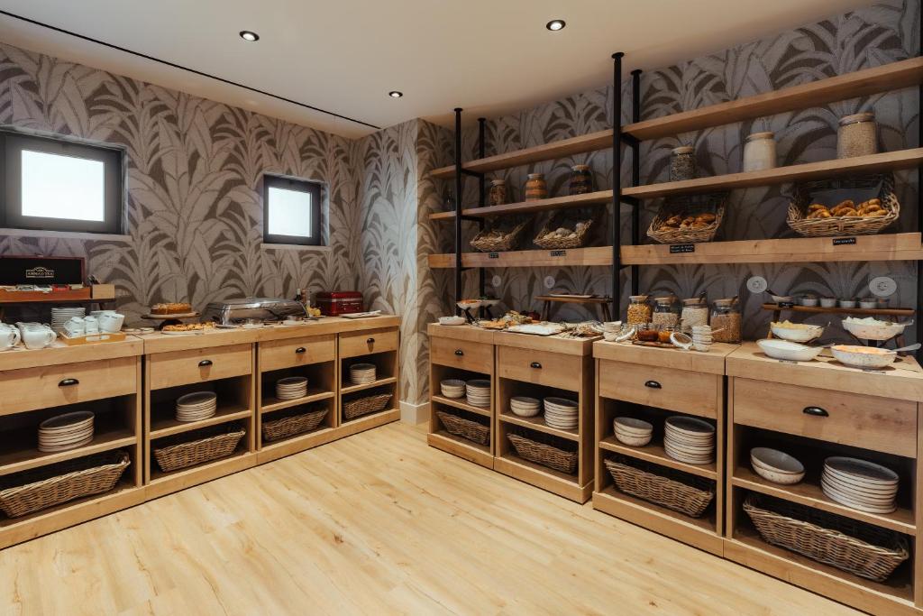 a room with wooden shelves with dishes and plates at AlmaLusa Comporta in Comporta