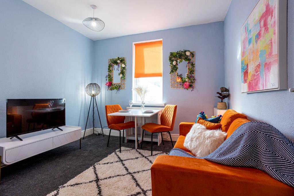 a living room with a couch and a table at Charles Alexander Short Stay - Botanical House in Cleveleys