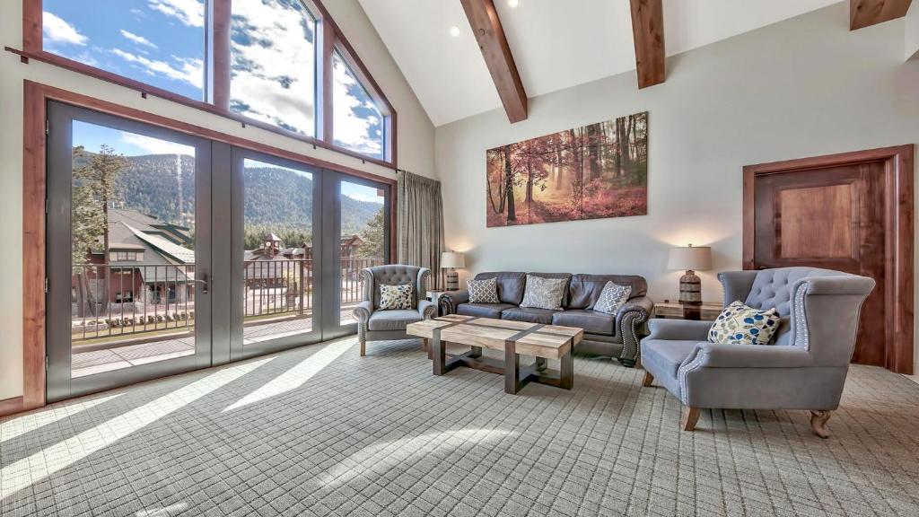 a living room with a couch and chairs and windows at Zalanta 325 in South Lake Tahoe