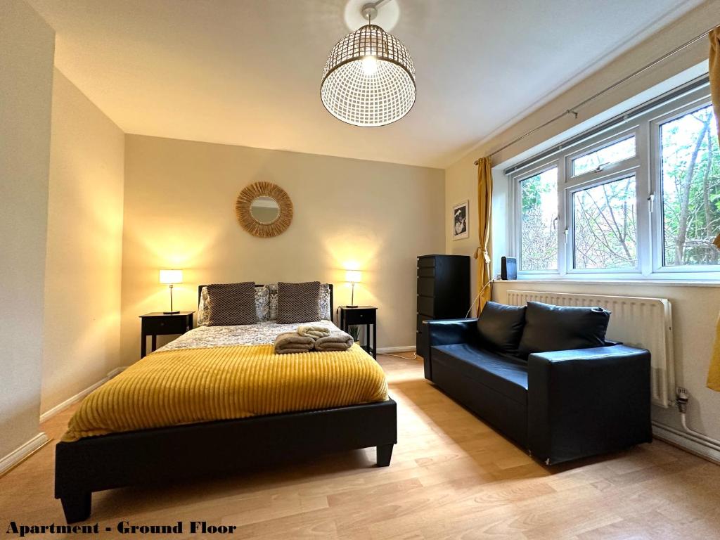 a bedroom with a bed and a chair in it at Charming Flats with Fast WIFI on the Famous Abbey Road in London