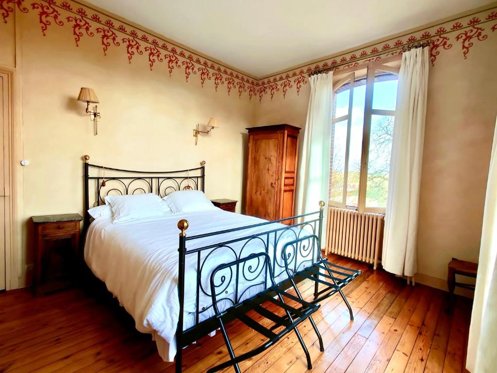 - une chambre avec un grand lit et une fenêtre dans l'établissement Chambres d'Hôtes Clisson Coeur, à Clisson