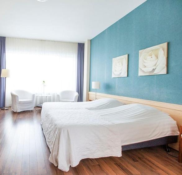Postel nebo postele na pokoji v ubytování Hotel Gevers