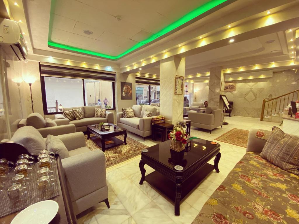 a large living room with couches and a table at Anbat Midtown Hotel in Wadi Musa