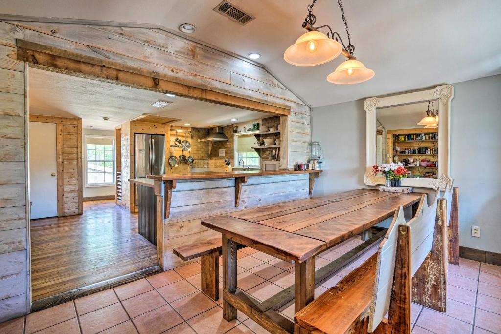 a kitchen with a wooden table in a room at Waterfront Guadalupe River Lodge Home with Dock! in Seguin