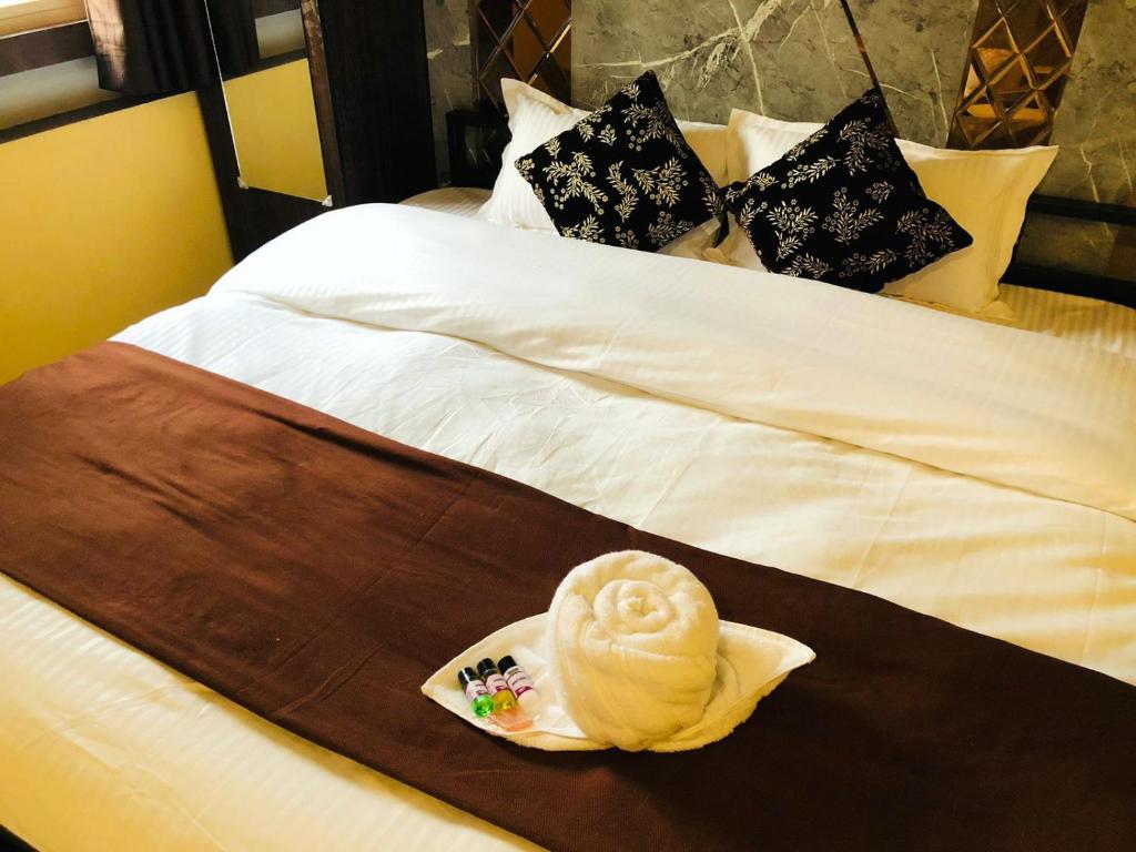 a hotel room with two beds with ice cream on them at The Madaar House in Varanasi