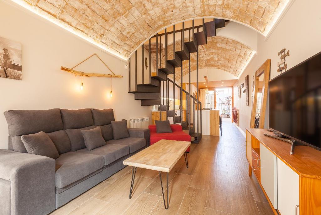 a living room with a couch and a table at Sant Rafel House in Arenys de Mar