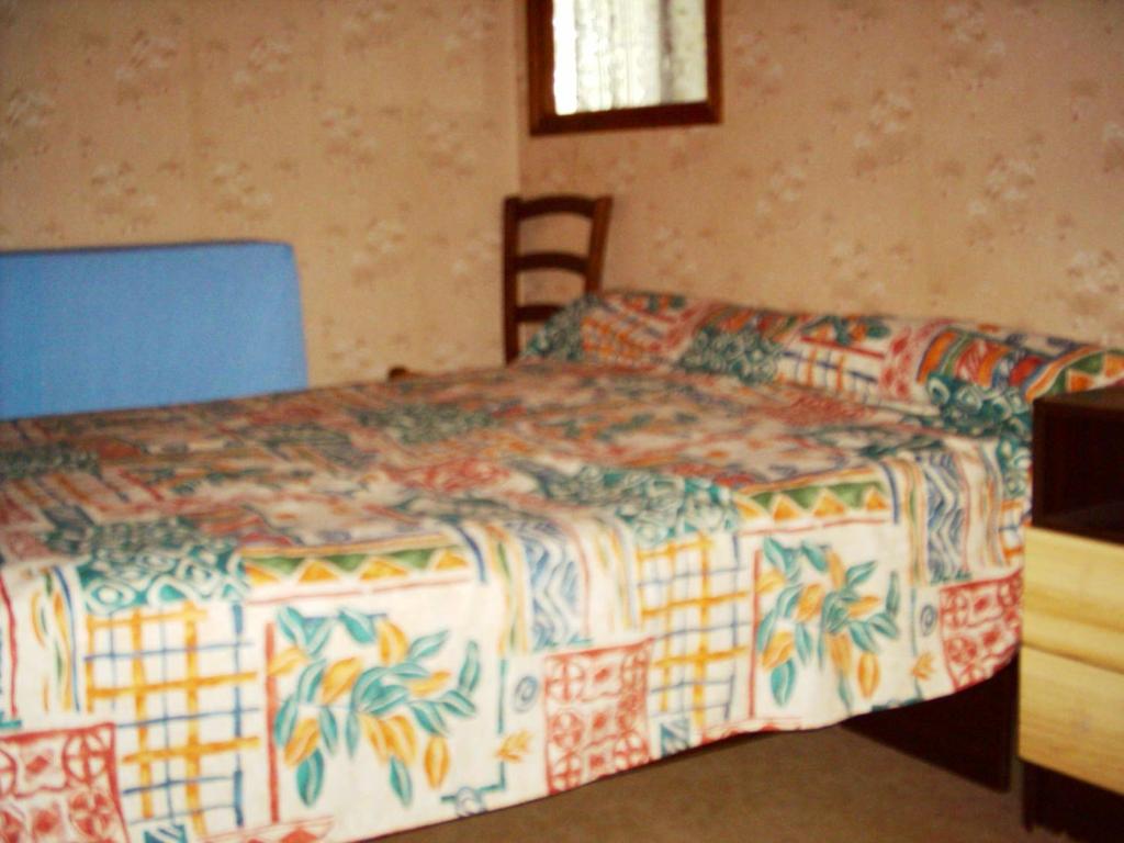 una camera da letto con un letto, un tavolo e delle sedie di Maison accueillante à Landos, 55 m², cheminée a Landos
