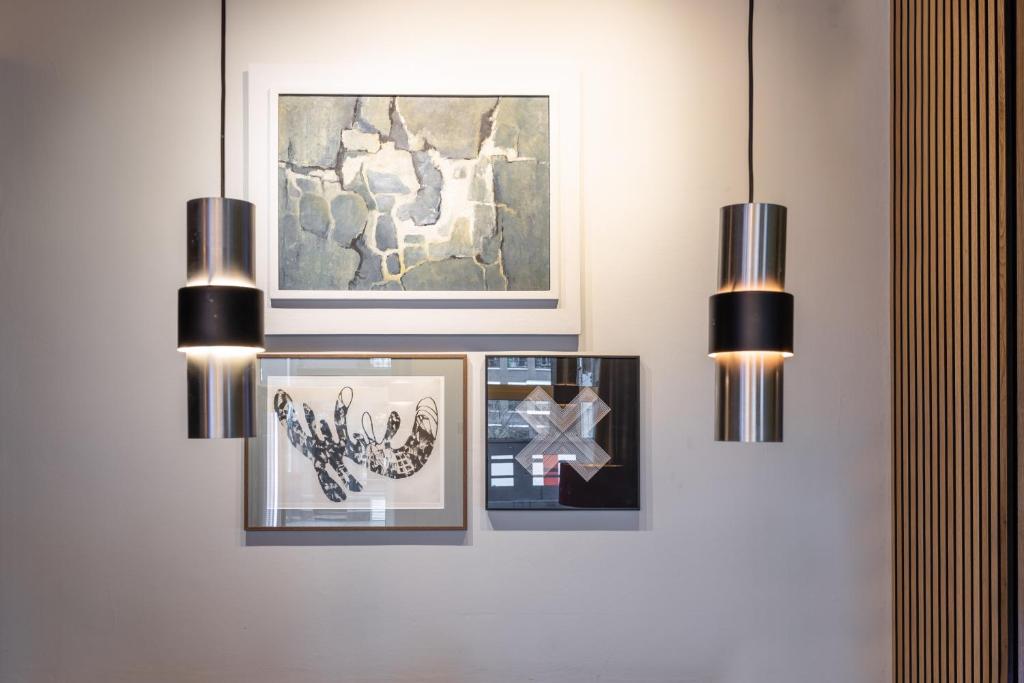 a wall with three pictures and two lights at Weber Studios in Amsterdam