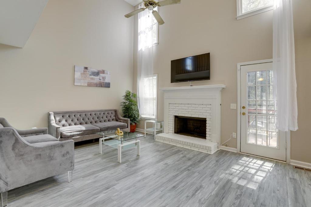 a living room with a couch and a fireplace at Stone Mountain Vacation Rental with Deck! in Stone Mountain