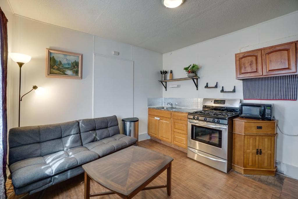 a living room with a couch and a kitchen at Pet-Friendly Vacation Rental Near Boyd Lake! in Loveland