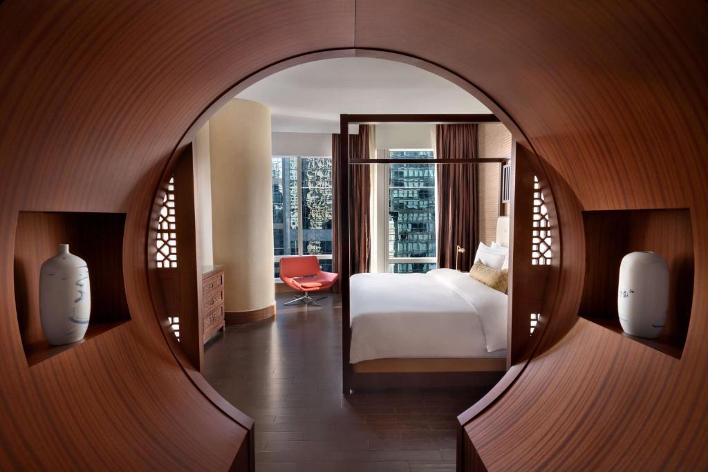 a hotel room with a bed and a large window at Shangri-La Toronto in Toronto