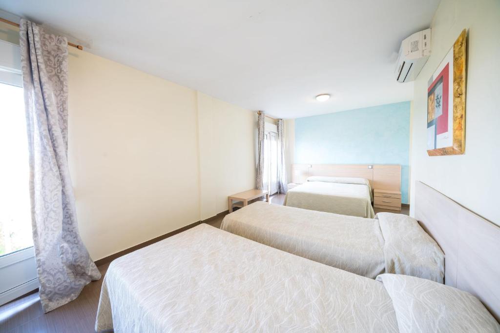 Postel nebo postele na pokoji v ubytování Hotel La Colina