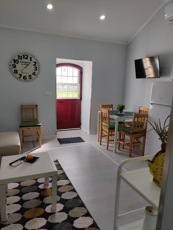 a living room with a red door and a table at Riviera Beach B in Praia da Vitória