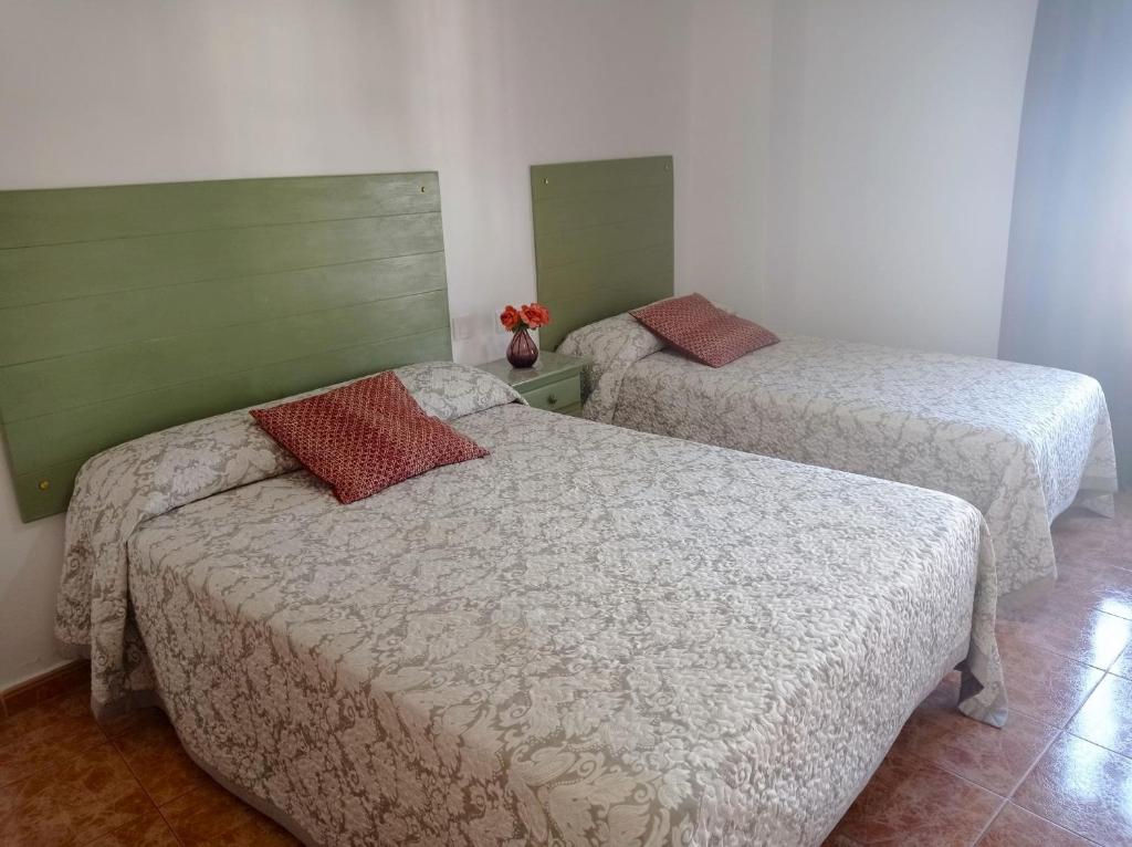 a room with two beds at Hostal Buena Vista in Vejer de la Frontera