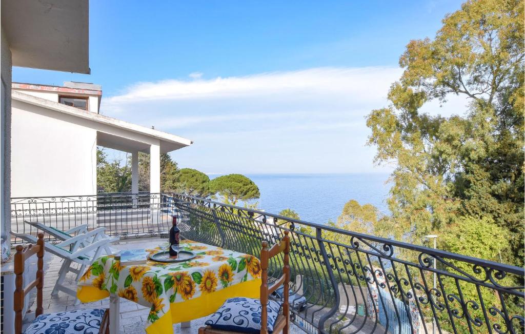 balcón con mesa y vistas al océano en Villa Delia, en Stalettì