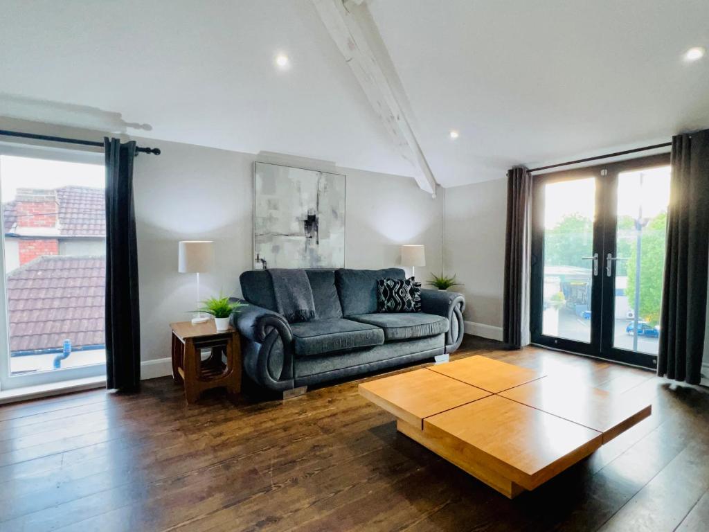 a living room with a couch and a coffee table at Smart-Home in Original Victorian Building in Bristol