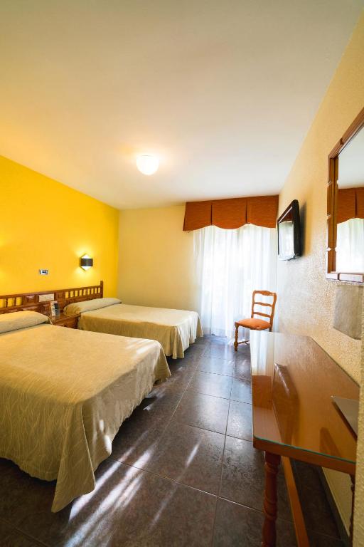 Postel nebo postele na pokoji v ubytování Hotel La Colina