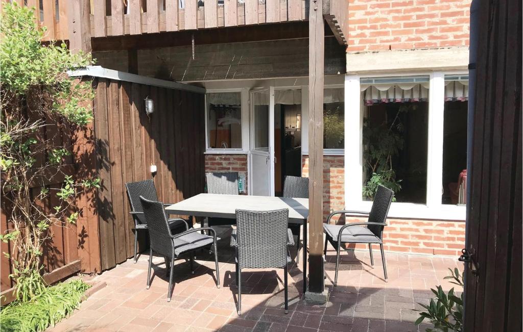 a patio with a table and chairs on a brick patio at Nice Home In Ystad With 4 Bedrooms And Wifi in Ystad