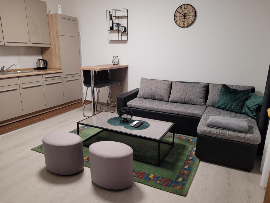 a living room with a couch and a table at Kod Dide - entry with pin 0-24h in Slavonski Brod