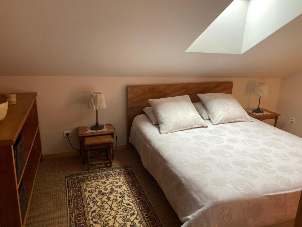 a bedroom with a bed with two pillows on it at Gite Le Cerneux Haut Doubs in La GrandʼCombe-Châteleu