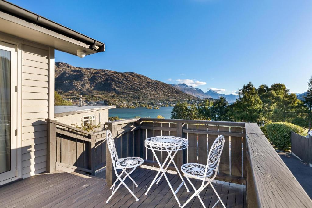 a deck with two chairs and a table with a view at Lake and Mountain view living in Queenstown
