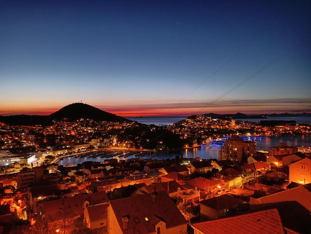 a view of a city at night with a town at Rooms Ivan in Dubrovnik