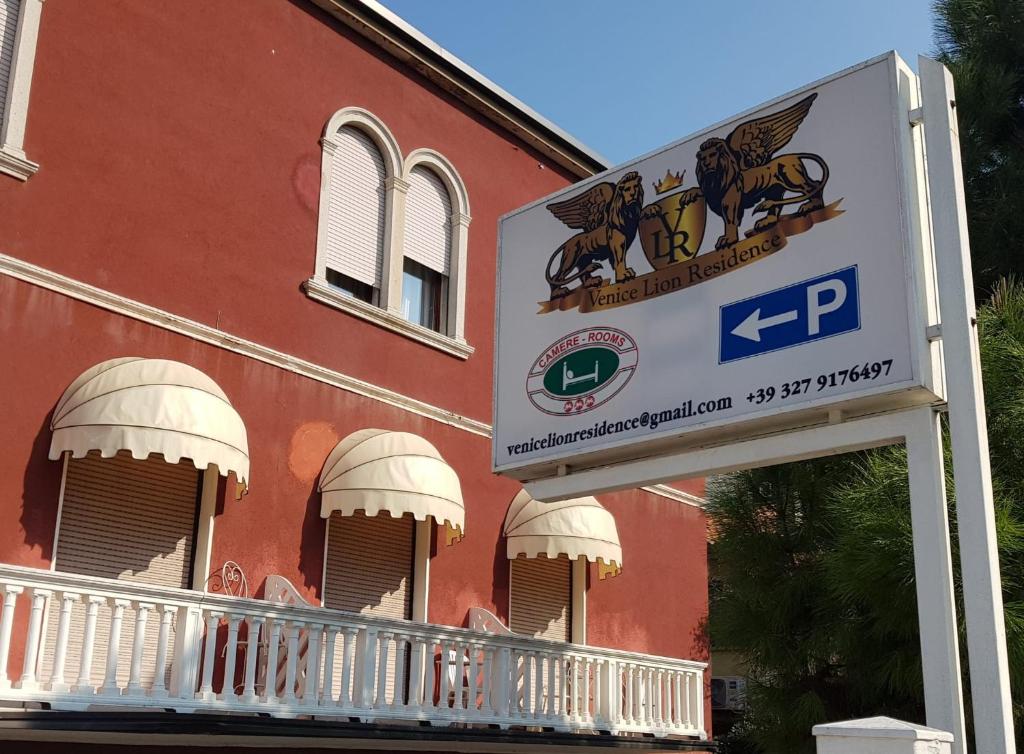 znak przed czerwonym budynkiem w obiekcie Venice Lion Residence - Vespucci w Mestre