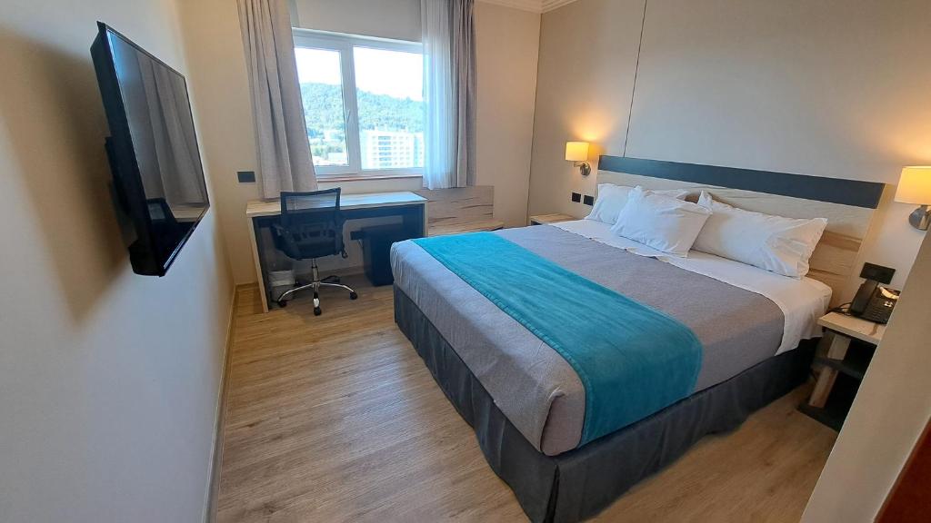 Una cama o camas en una habitación de Hotel Diego de Almagro Temuco Express