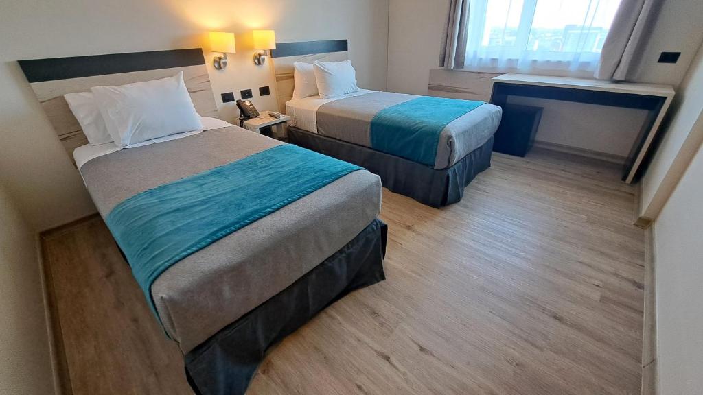 Una cama o camas en una habitación de Hotel Diego de Almagro Temuco Express