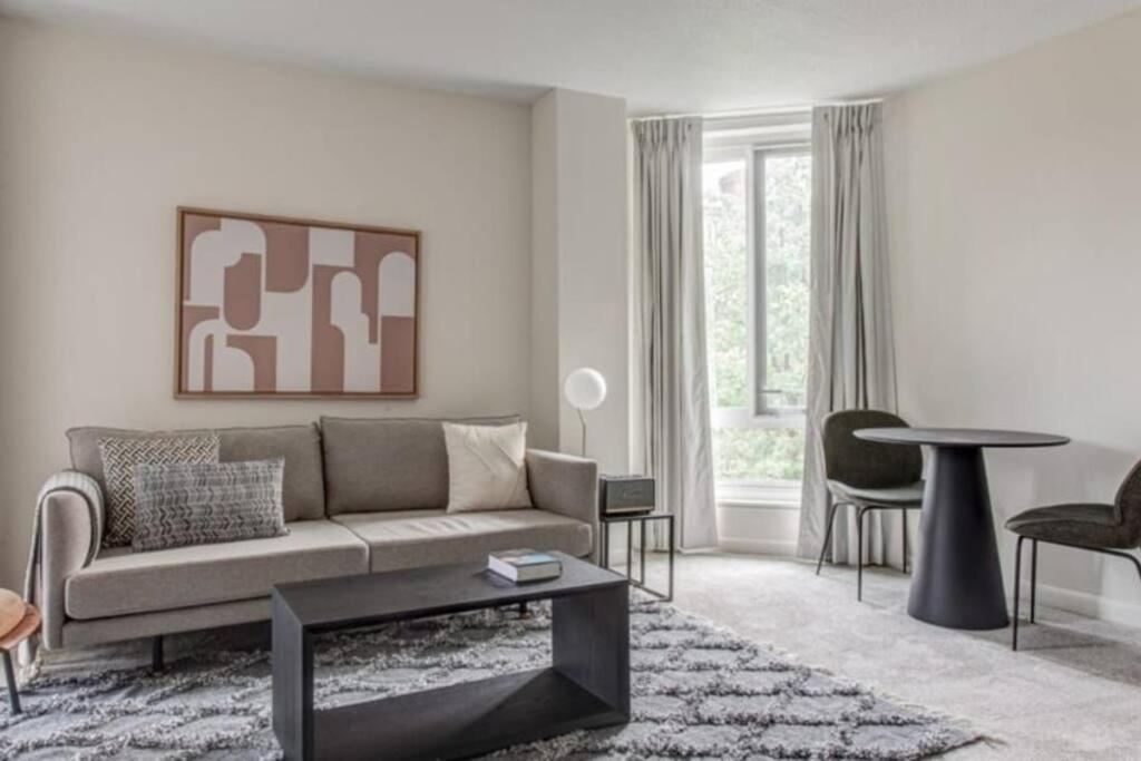 a living room with a couch and a table at BackBay Center Lux 2BR 2BA condo in Boston