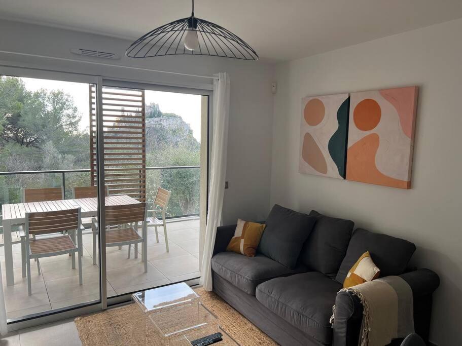 a living room with a couch and a table at Prestige View 411 in Èze