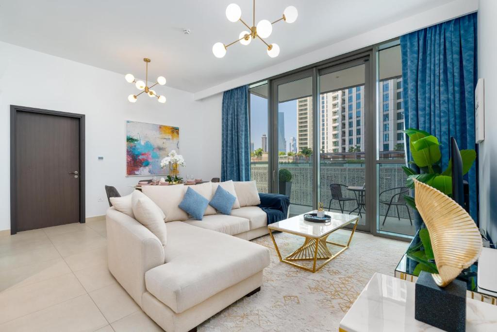 a living room with a couch and a table at Ultimate Stay / Directly Connected to Dubai Mall in Dubai