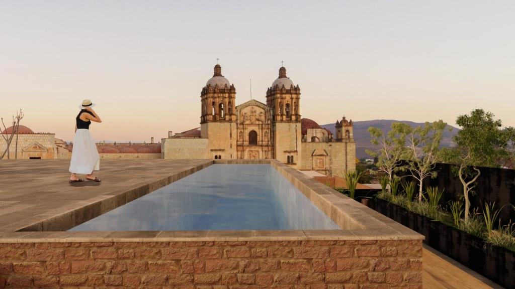 a woman standing on the roof of a building at Otro Oaxaca, a Member of Design Hotels in Oaxaca City