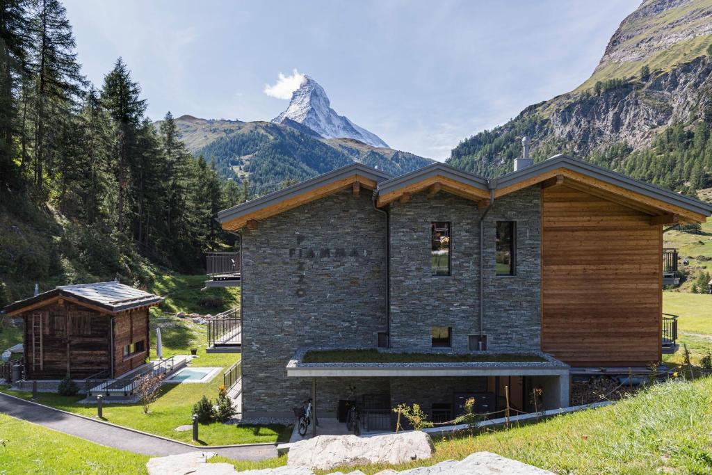 a house with a mountain in the background at Apartment in Chalet Pizzo Fiamma in Zermatt