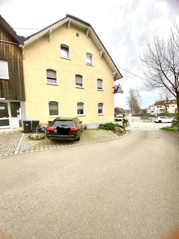a car parked in front of a house at Pension Hirsch in Berg