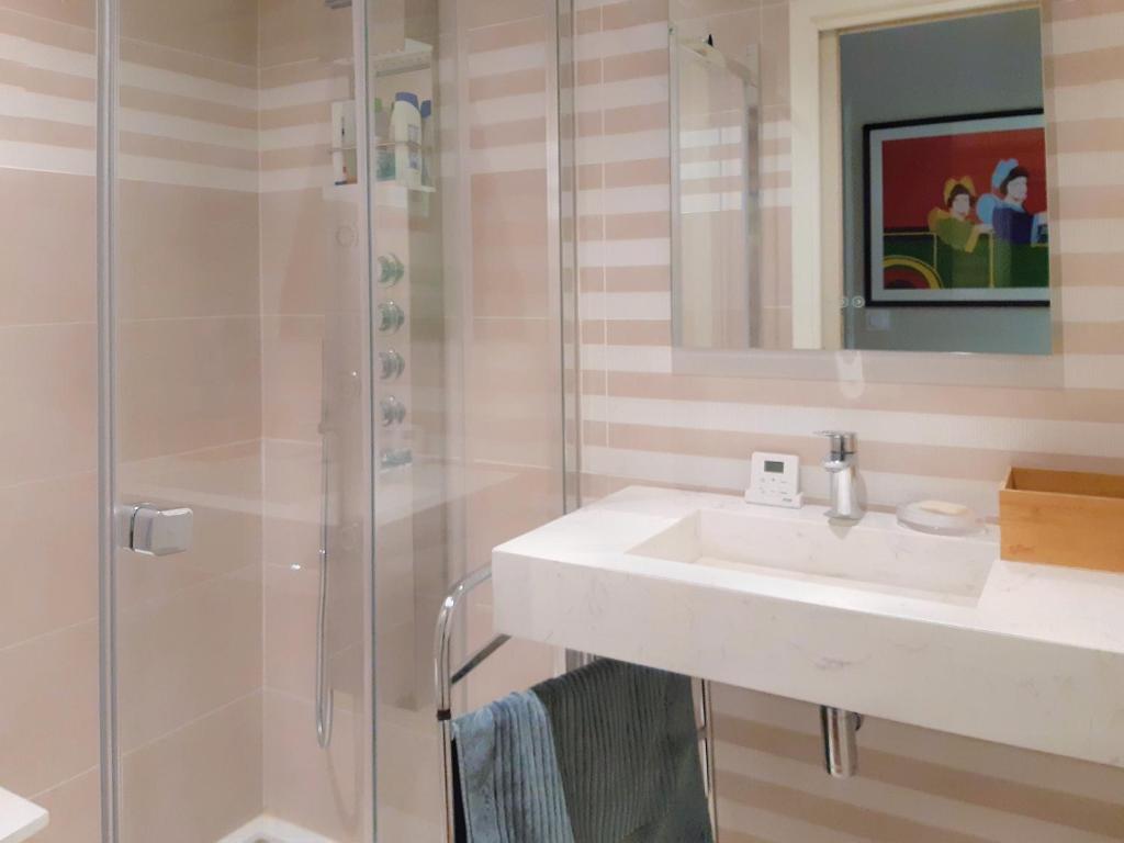 a bathroom with a sink and a shower at Villa Saint Kirio - piscine et spa in Morlaix