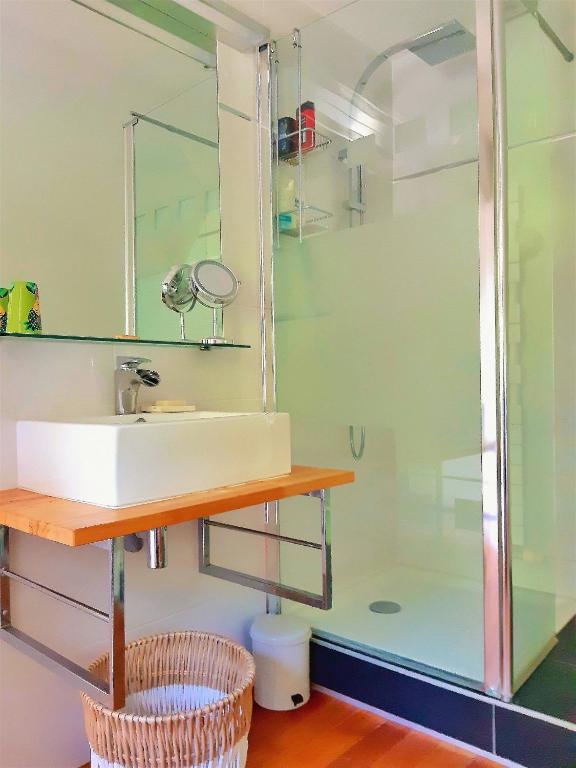 a bathroom with a sink and a shower at Villa Saint Kirio - piscine et spa in Morlaix