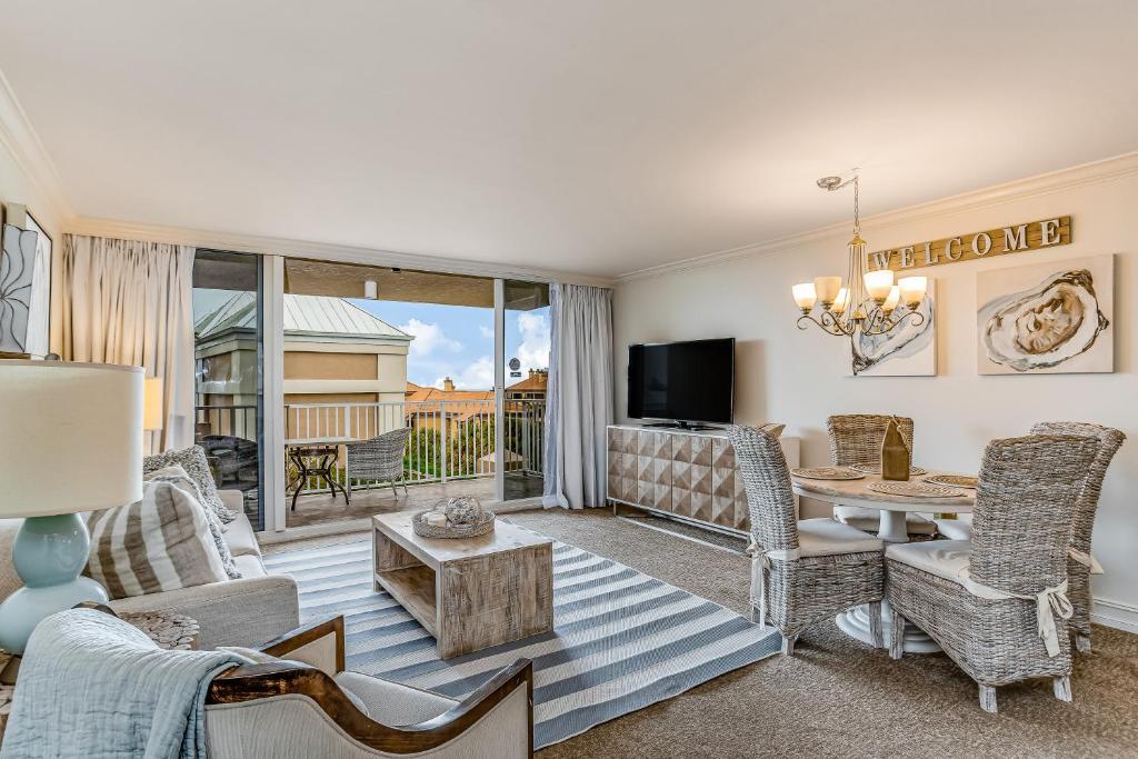 a living room with a table and chairs at Marco Beach Ocean Resort 614 in Marco Island