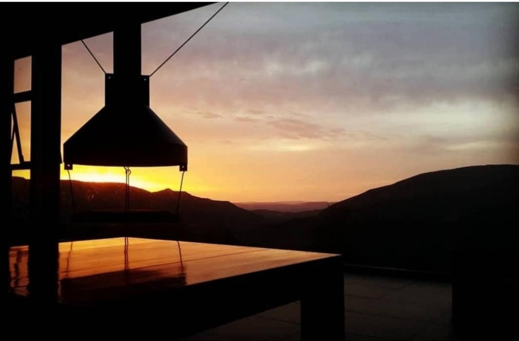 a view of the sunset from a room with a light at HOTEL PIORNEDO in Lugo