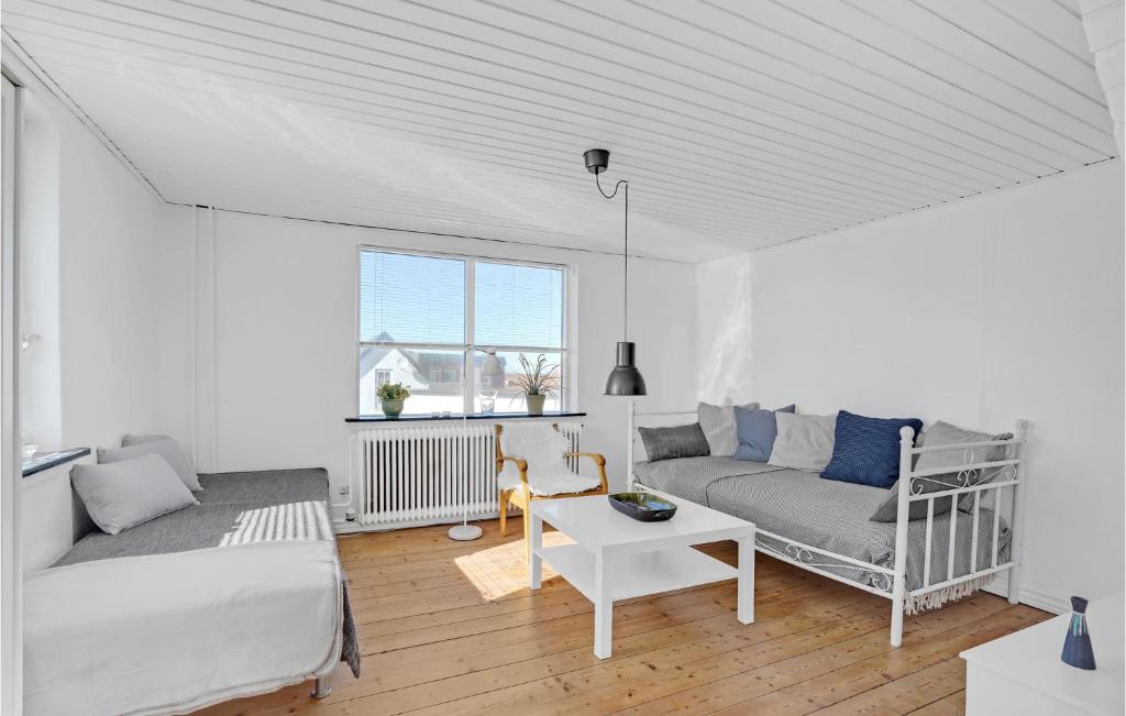 Sala de estar blanca con cama y sofá en Beautiful Apartment In Hirtshals With Kitchen, en Hirtshals