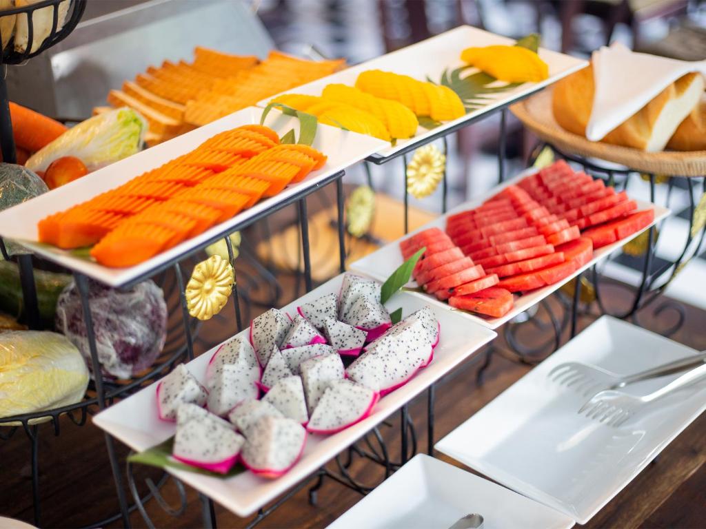 a display of different types of food on trays at Chateau d'Angkor La Residence in Siem Reap