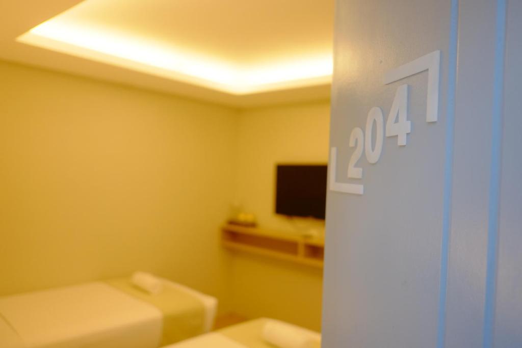 Postel nebo postele na pokoji v ubytování Hotel Simone Kalibo