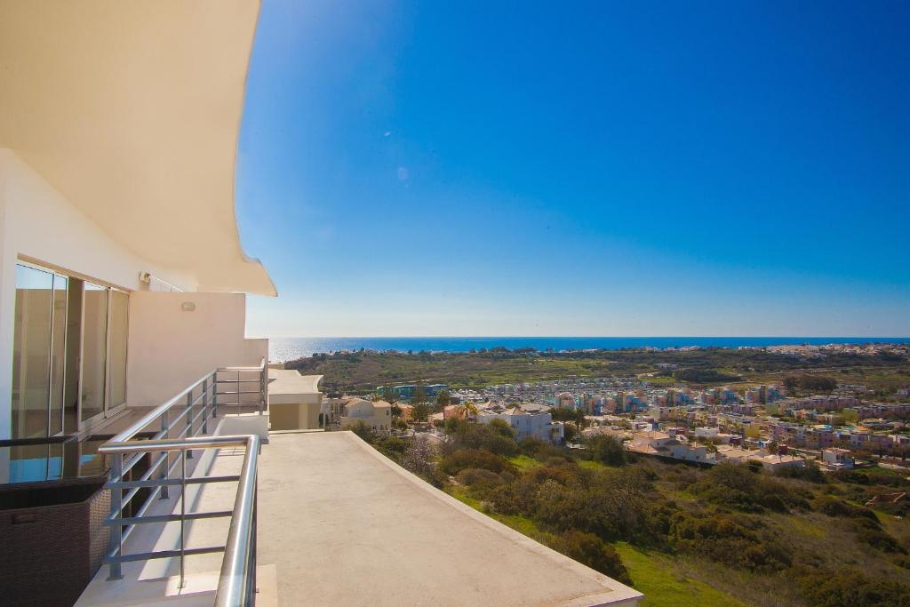a balcony with a view of a city at Sea View Penthouse in Albufeira in Albufeira