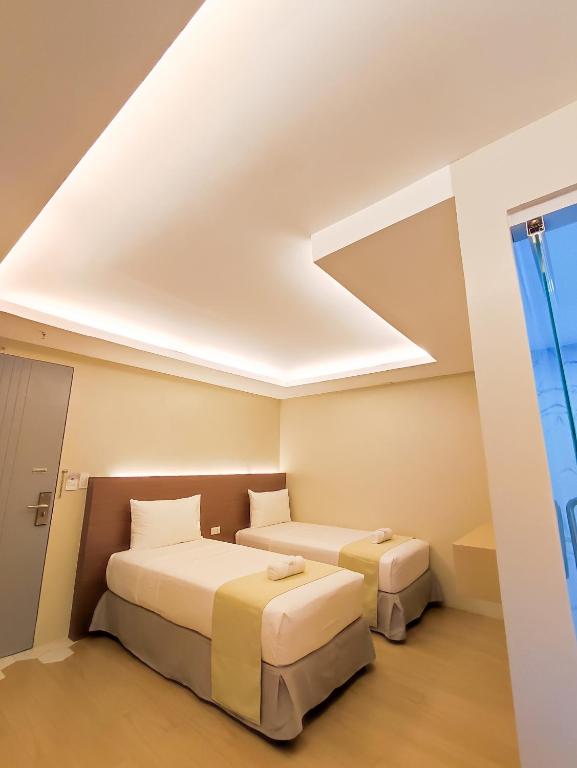 Postel nebo postele na pokoji v ubytování Hotel Simone Kalibo